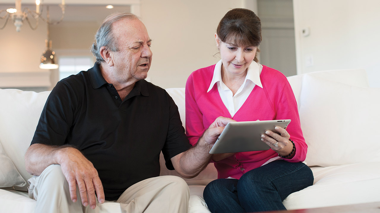 man and woman looking at a tablet